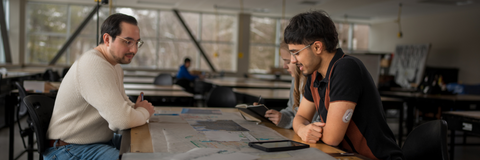 students sitting across table from manager