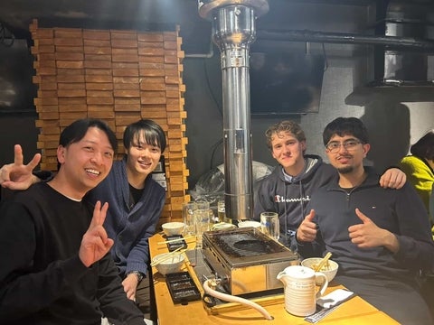 Vivek Upadhyay dining with three friends at a restaurant in Japan.