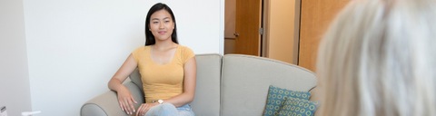 A woman sitting on a couch.