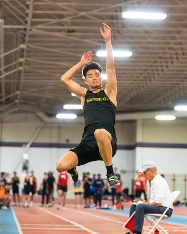 Nick Cahyono jumping in the air in sports uniform