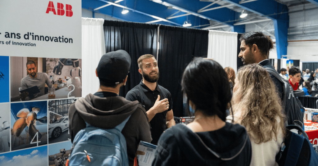 Students talking to an employer at a booth at P4E job fair.