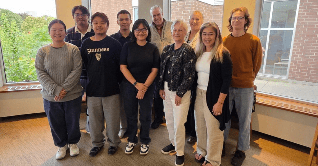 Group of people standing and smiling