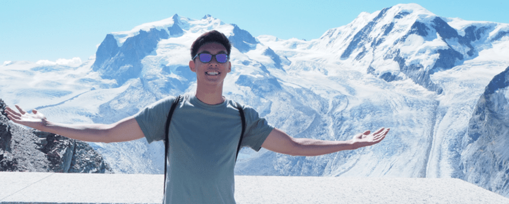 University of Waterloo Environment co-op student, Andrew Ding, smiling in front of mountain view