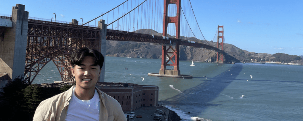 University of Waterloo Science co-op student, Jonny Hsu, smiling in front of the Golden Gate Bridge.