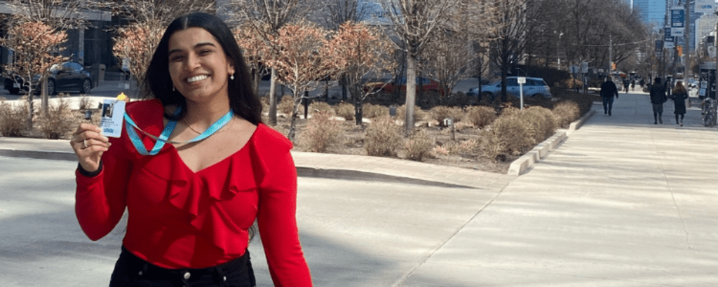 A photo of Tanveer smiling in front of the Toronto General Hospital building.