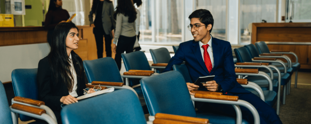 Two co-op students sitting in Tatham Centre preparing for their interviews.