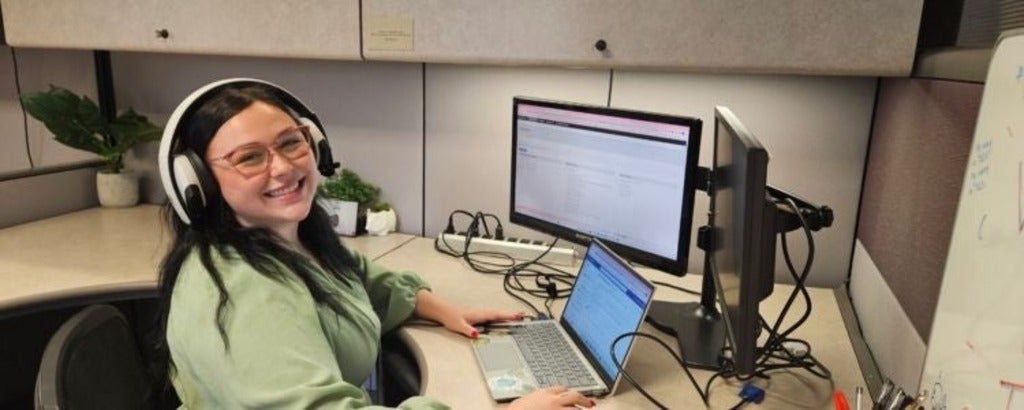 Willow Carmount sitting at her desk at Waterloo's IST department.