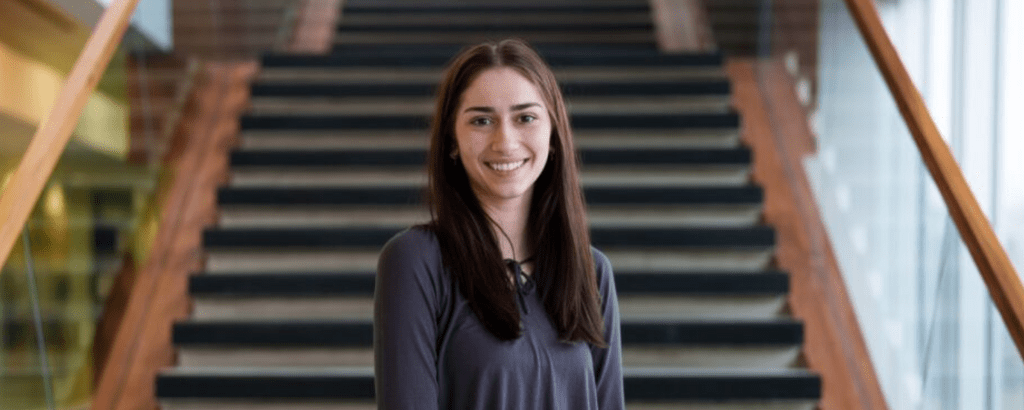 Milena Gojsevic smiling while standing in front of staircase