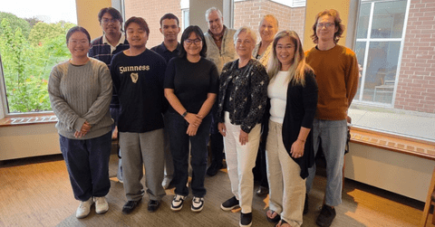 Group of people standing and smiling