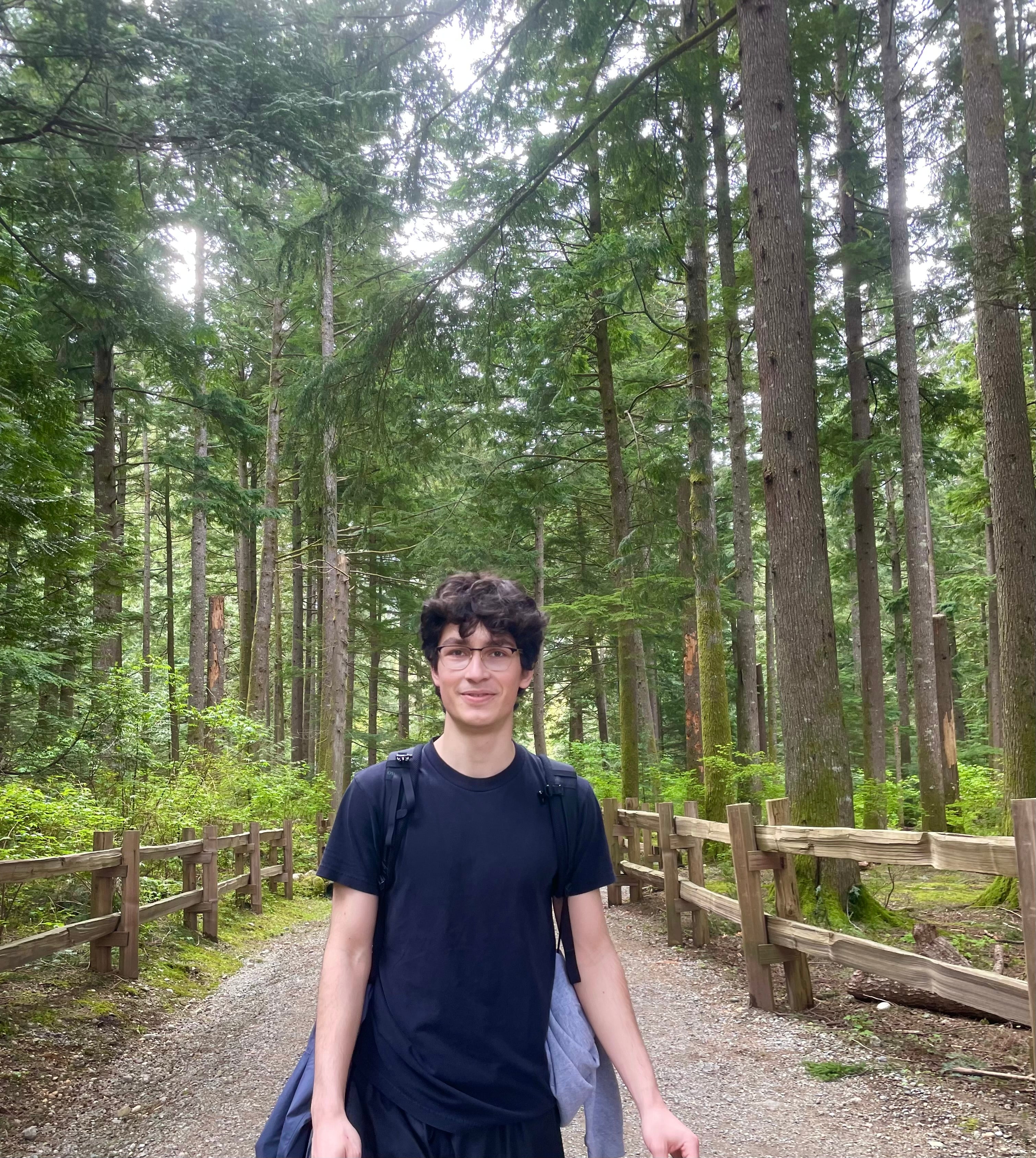 Andrei standing in a forest.