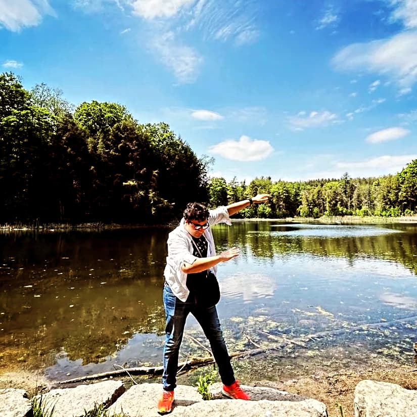 Bhagya dabbing in front of a pond.