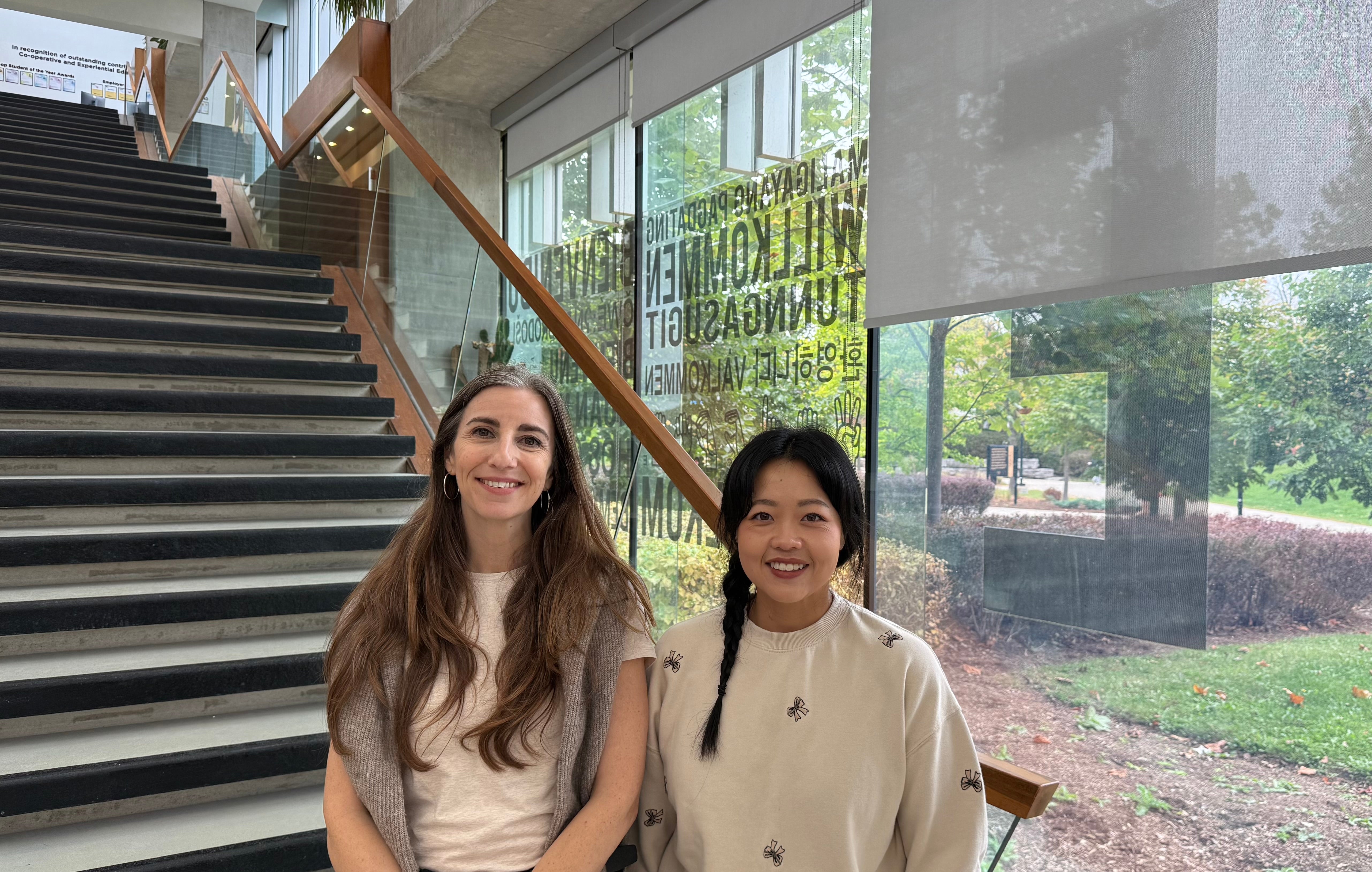 Women standing in front of staircase