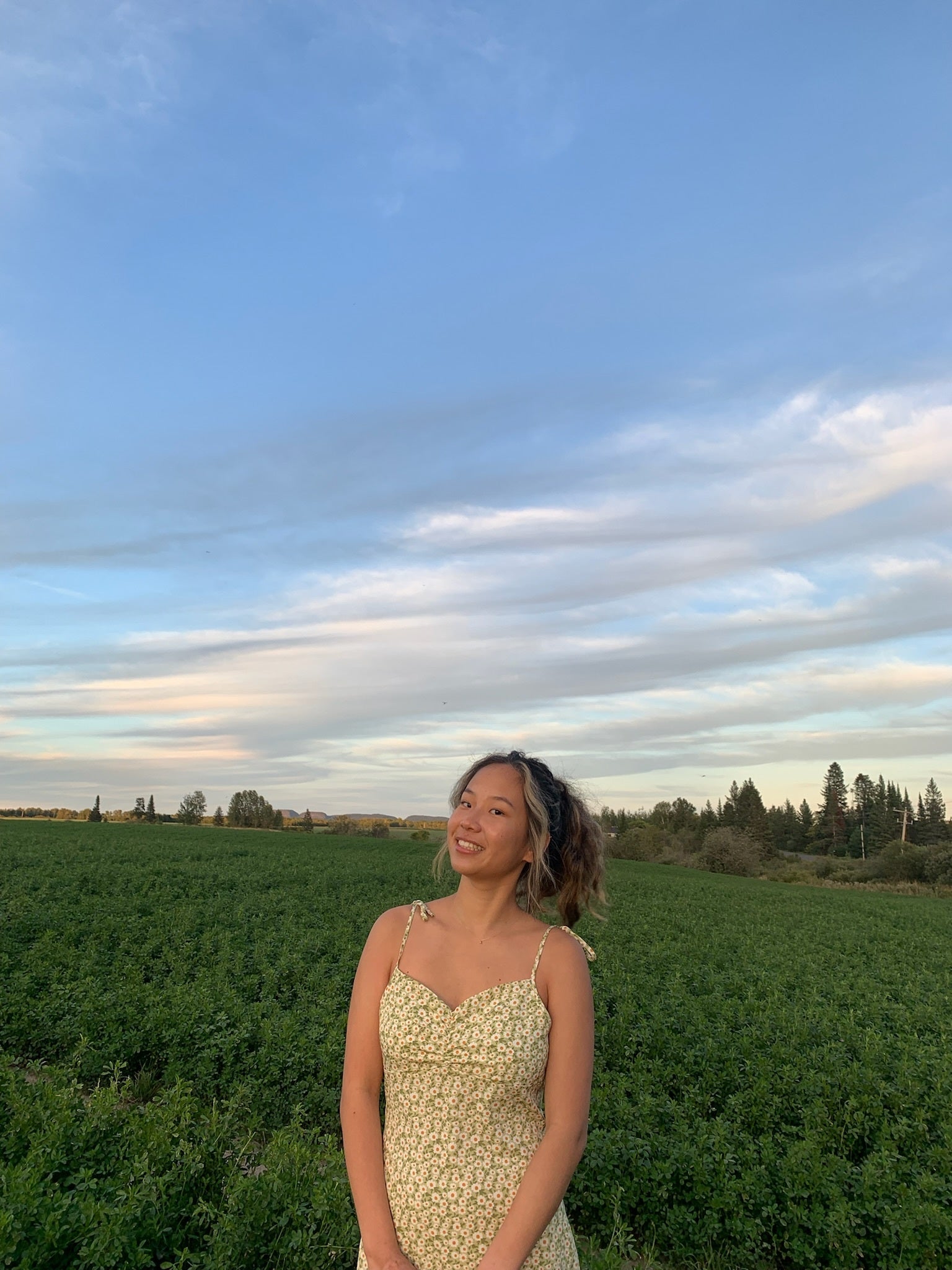 Daisy Shuyi Xiao smiling in a field