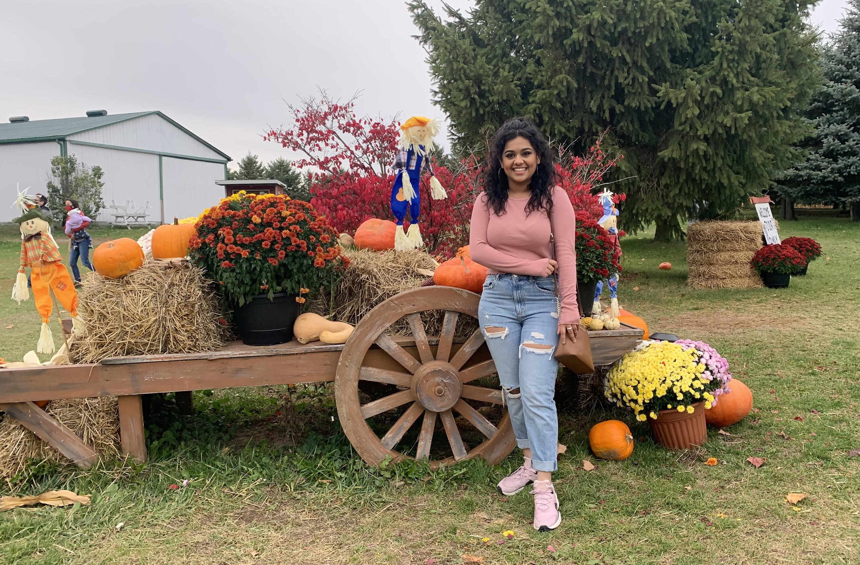 Nickie smiling with halloween decorations in a farm