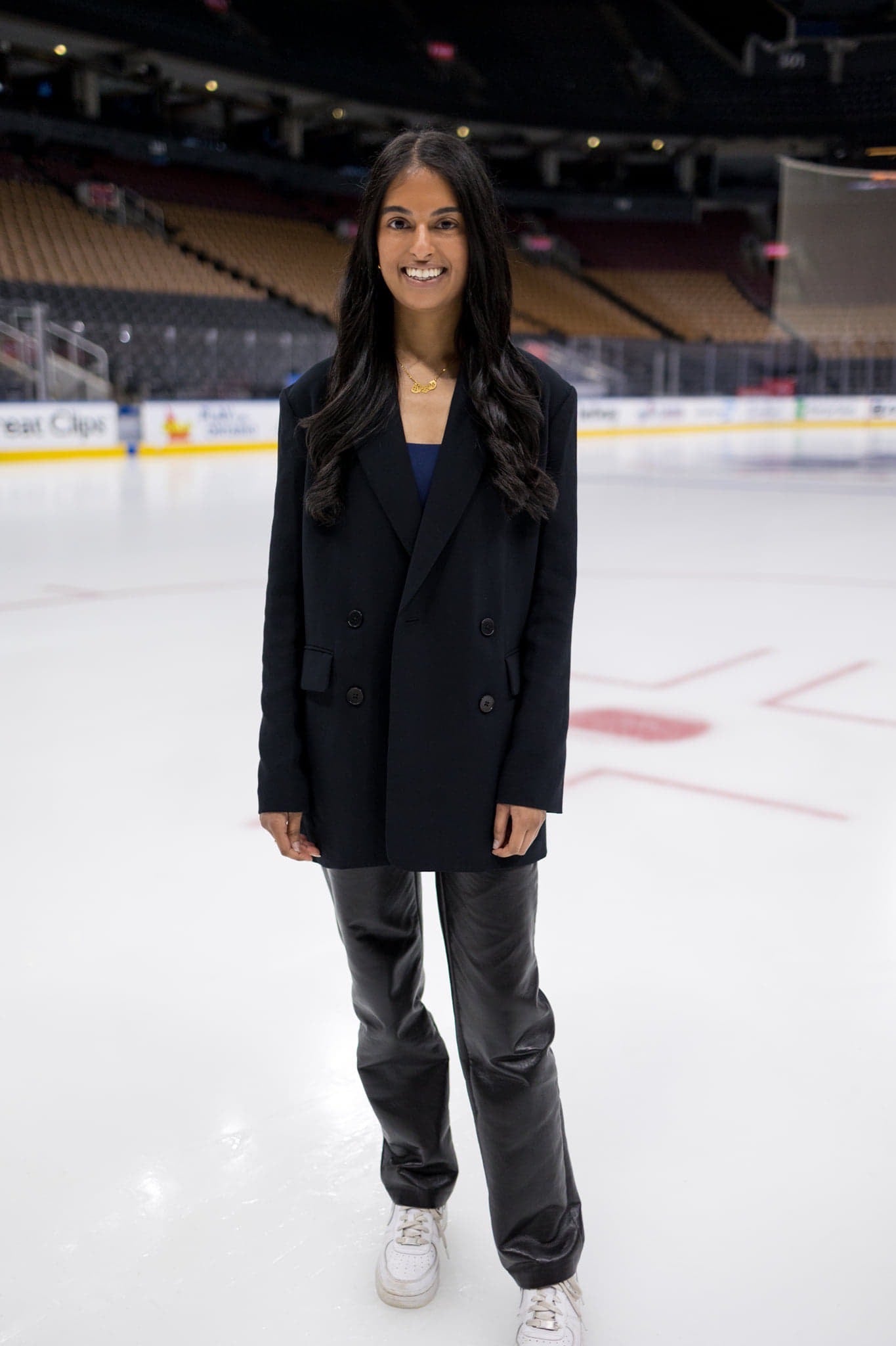 A photo of Riana standing on a hockey rink.