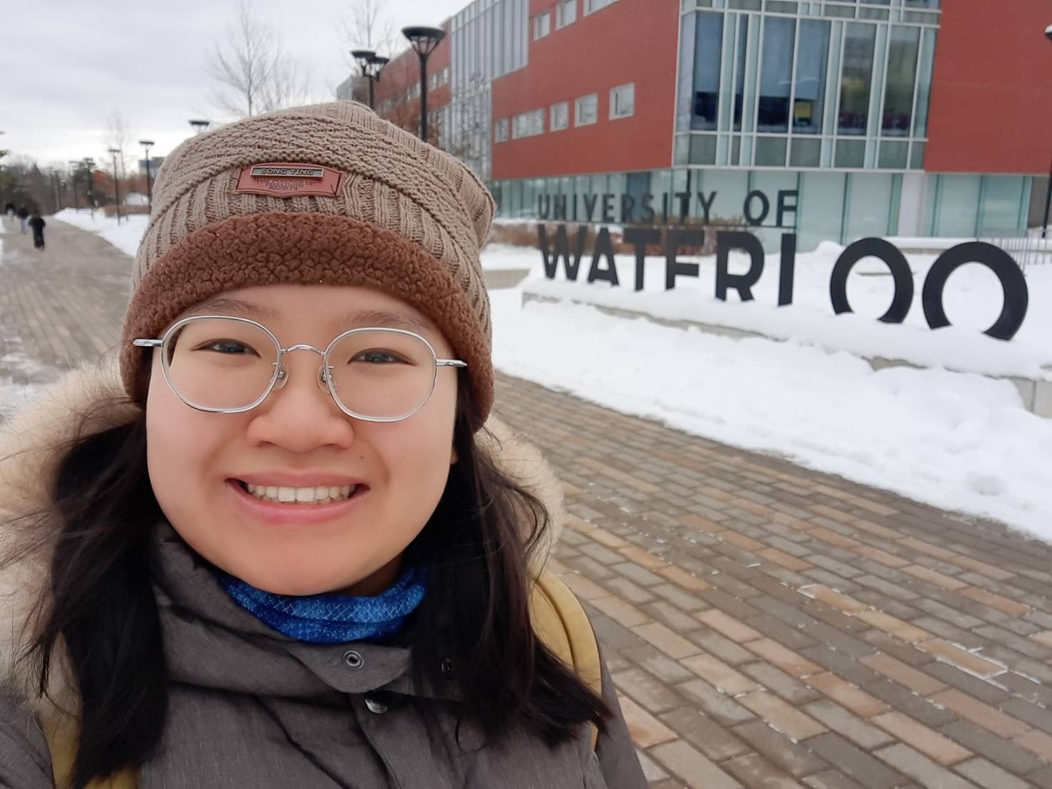 Nutnicha Suvittawat standing in front of a University of Waterloo sign