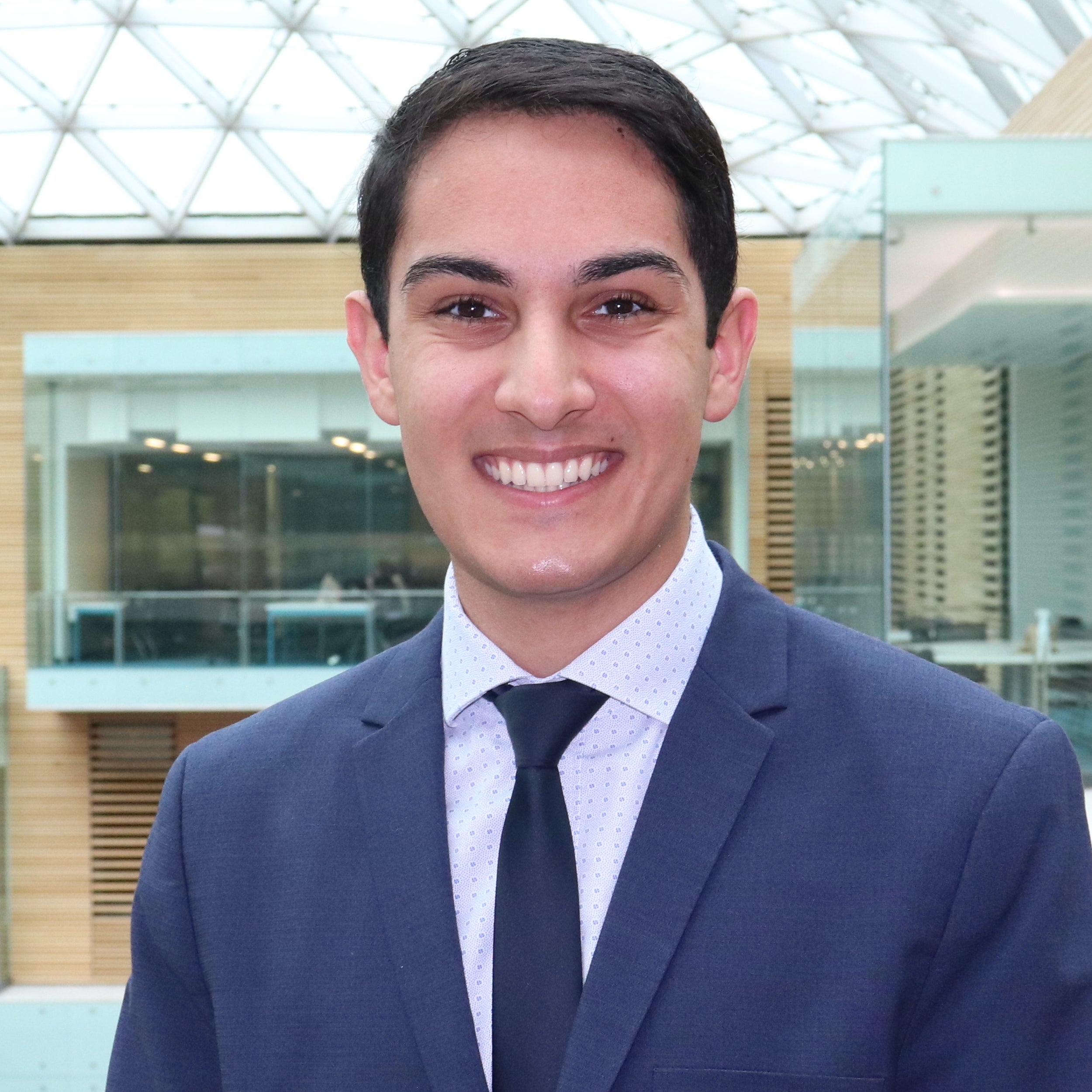 Jason in a suit, smiling