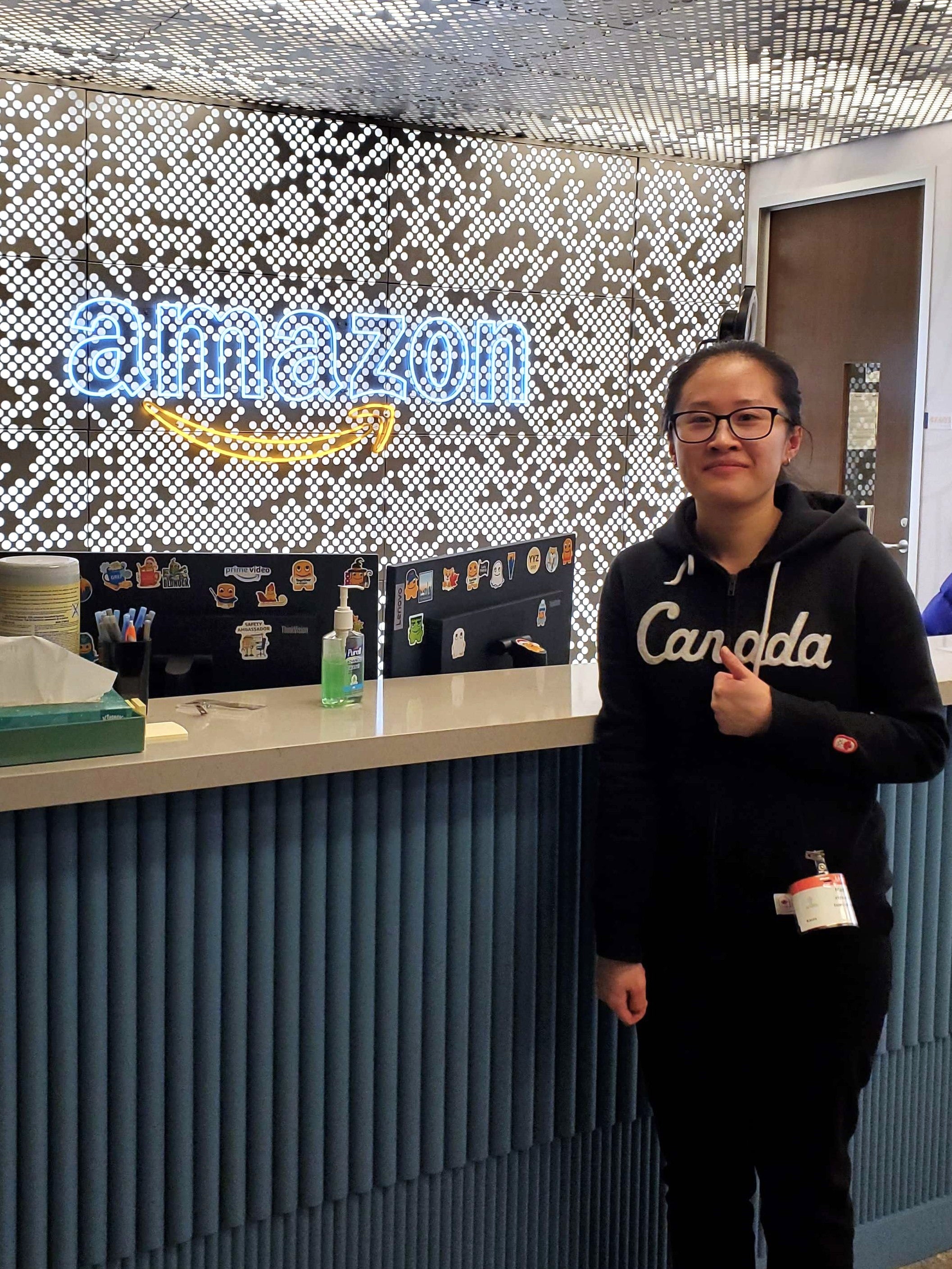 Karen Xie posing in front of Amazon sign