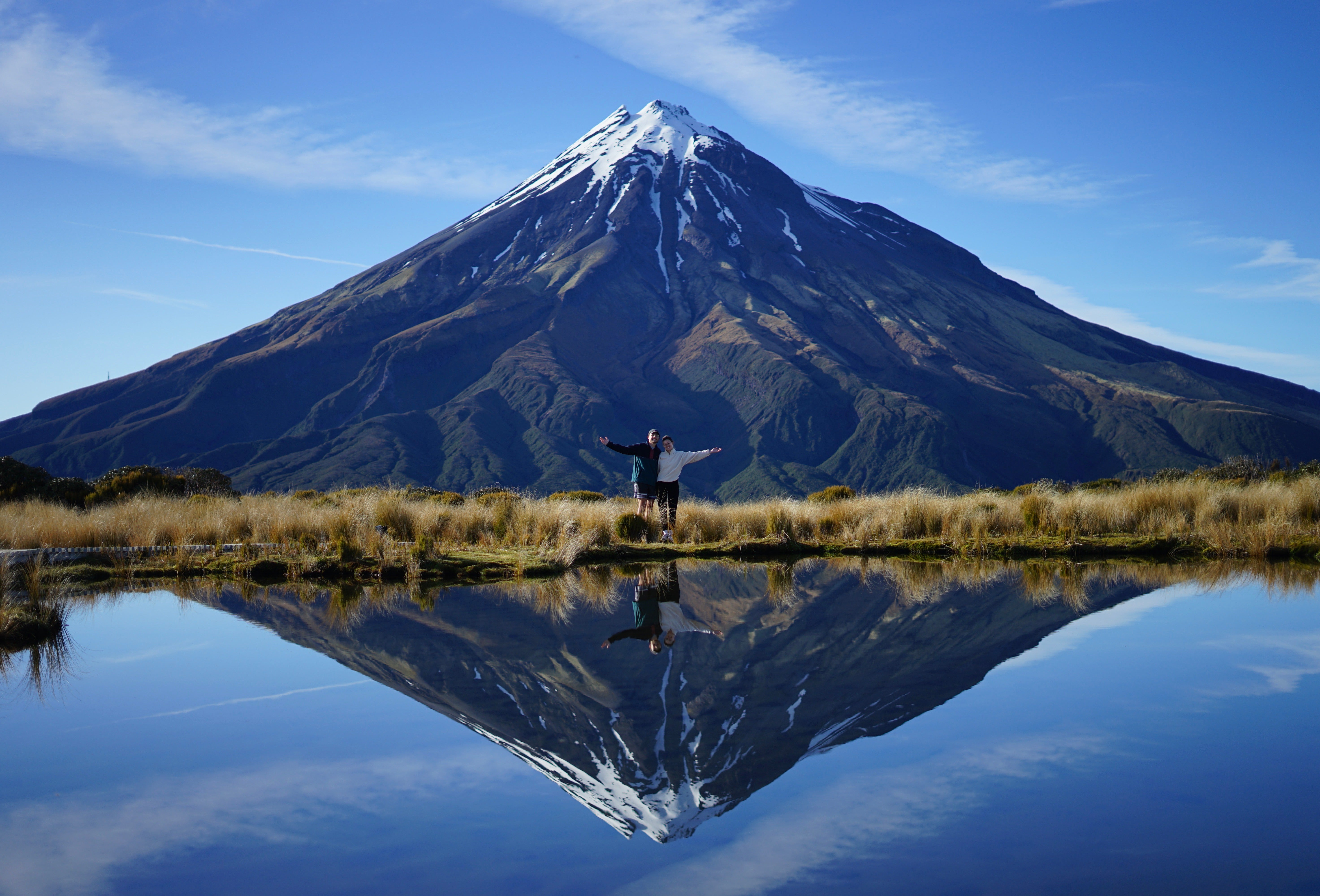 View of a mountain reflecting onto a body of water