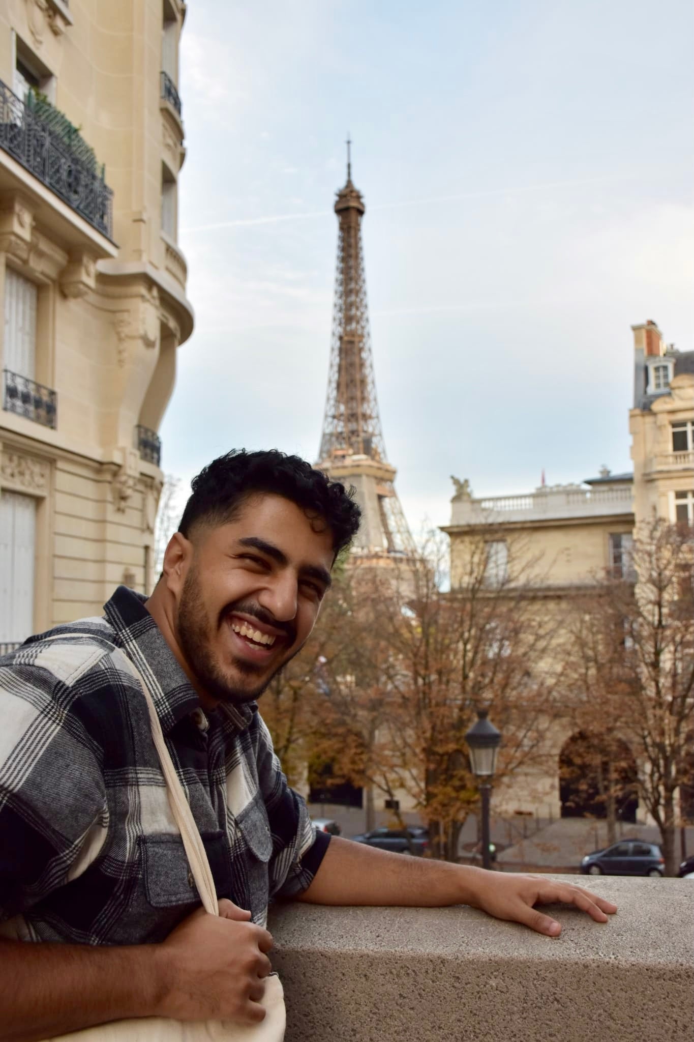 Michael smiling in front of the Eiffel Tower.