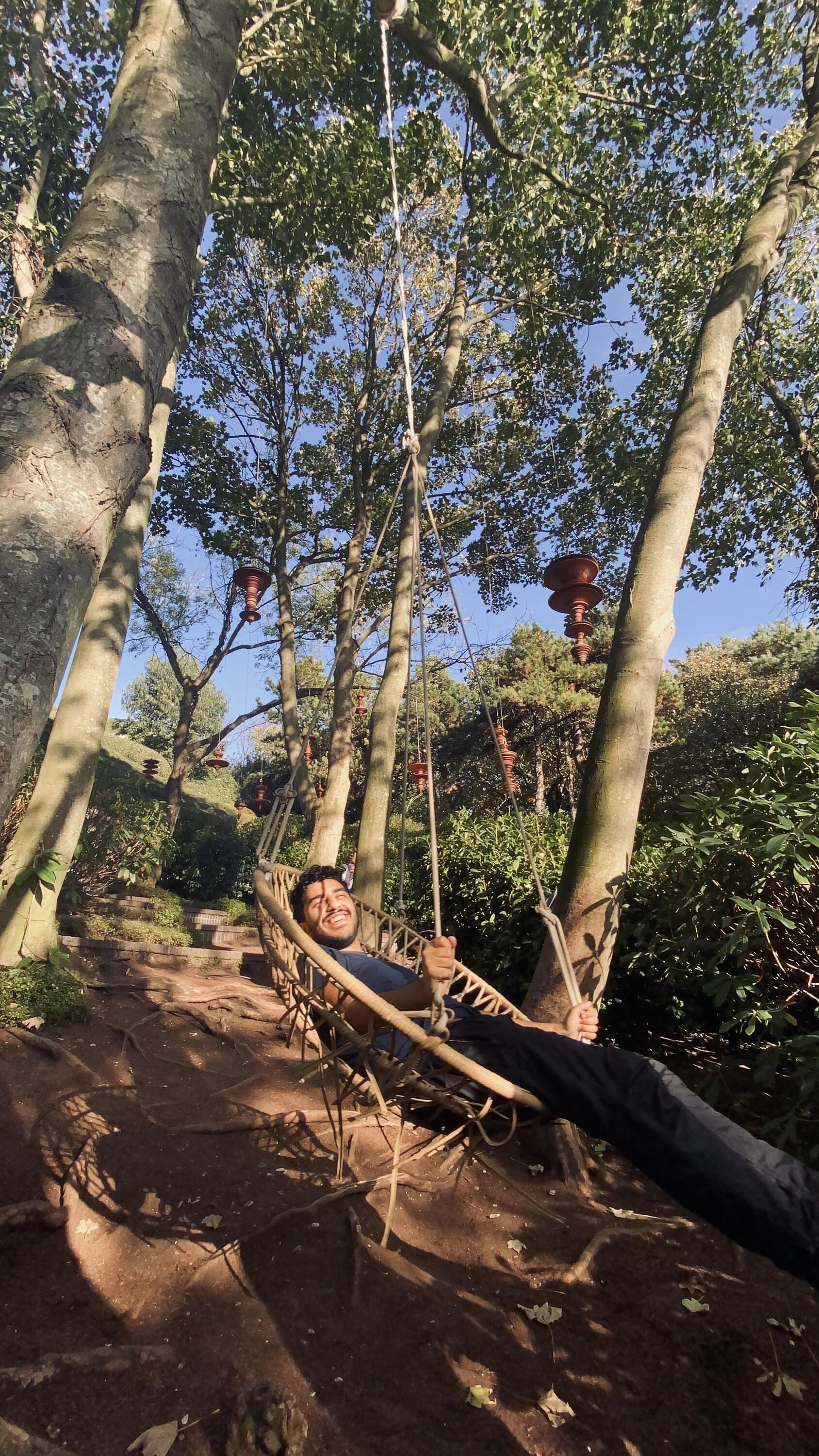 Michael smiling on a swing.