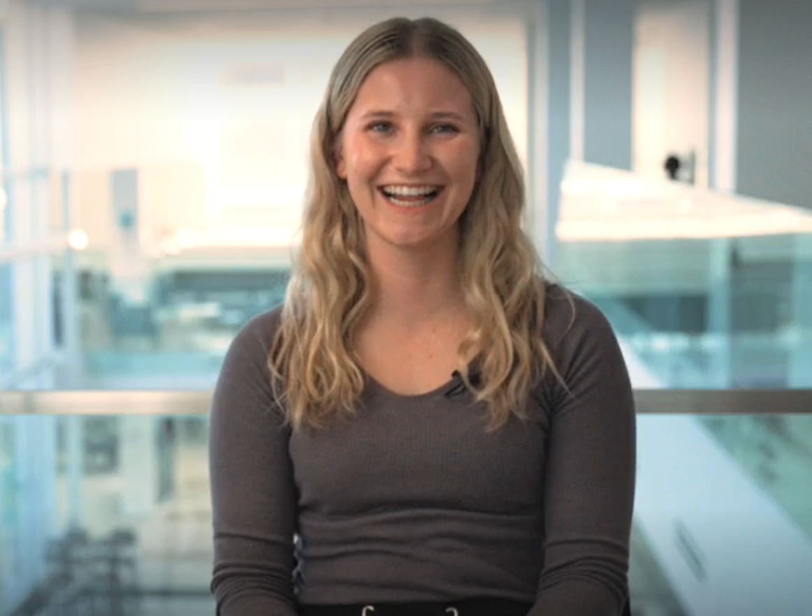 Photo of Madison sitting down and smiling during an interview.