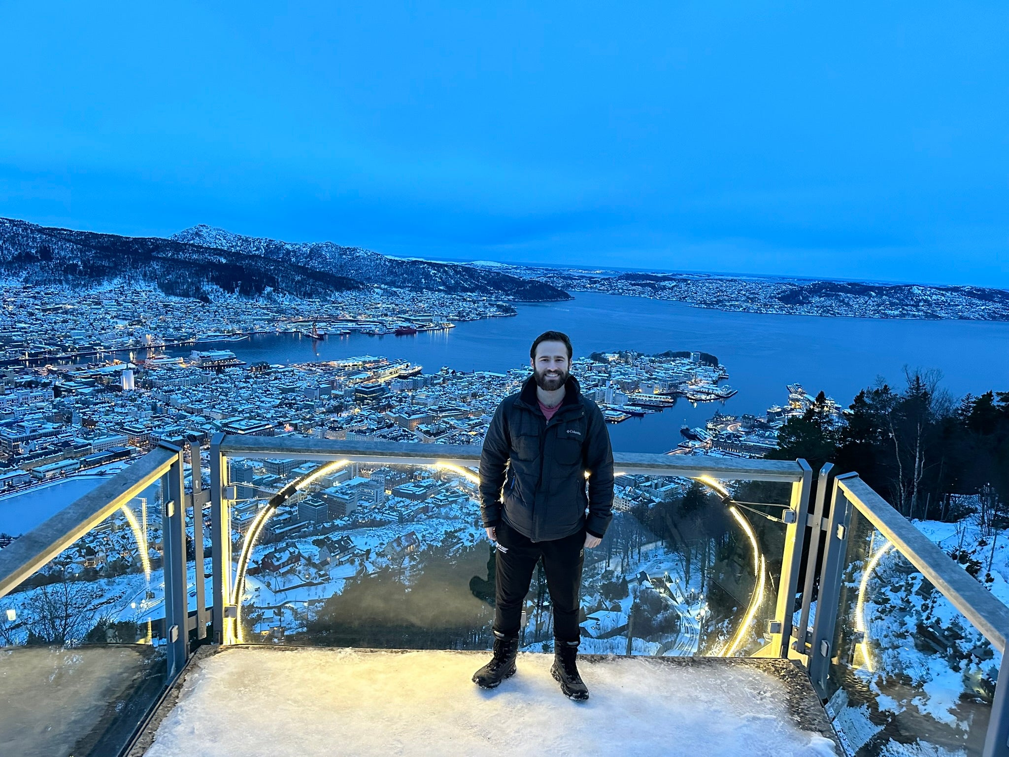 Shawn standing on a balcony, overlooking a snowy town.