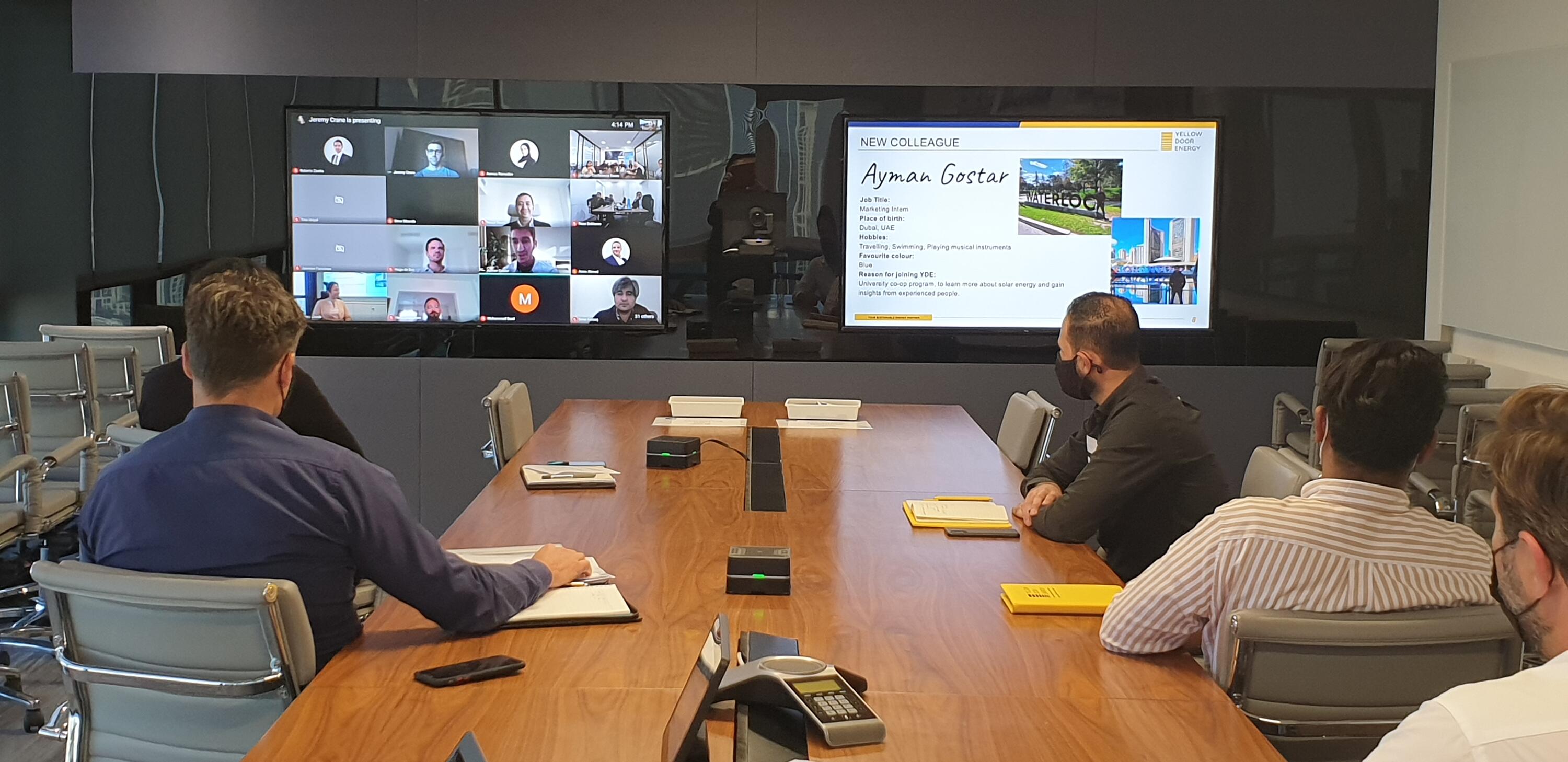 Ayman's co-workers watching a presentation