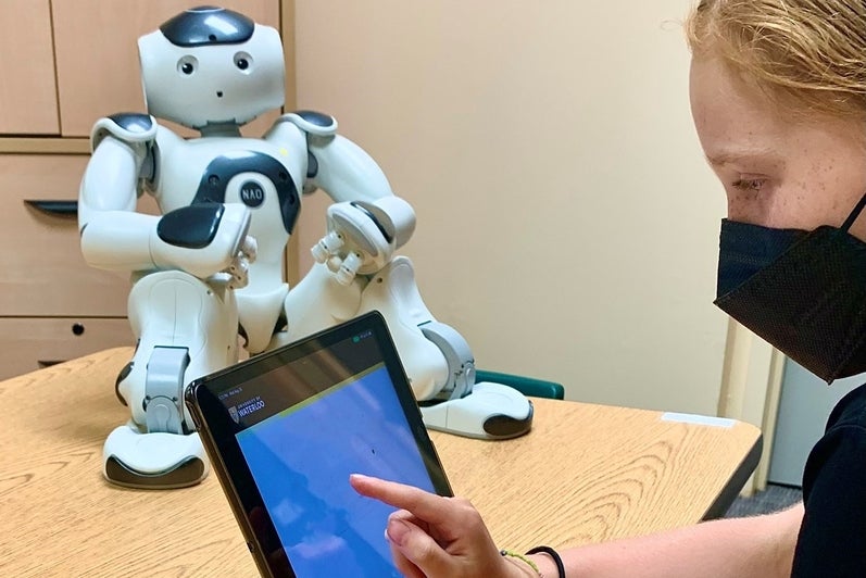 child participating in a study with the robot