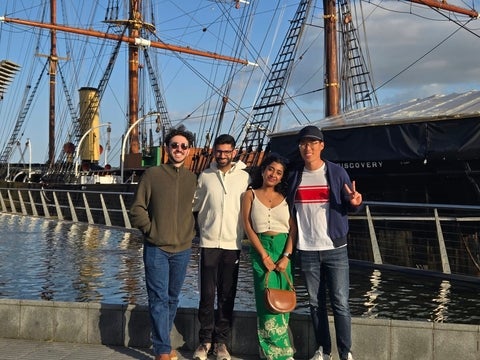 Lab Group Photo infront of a boat