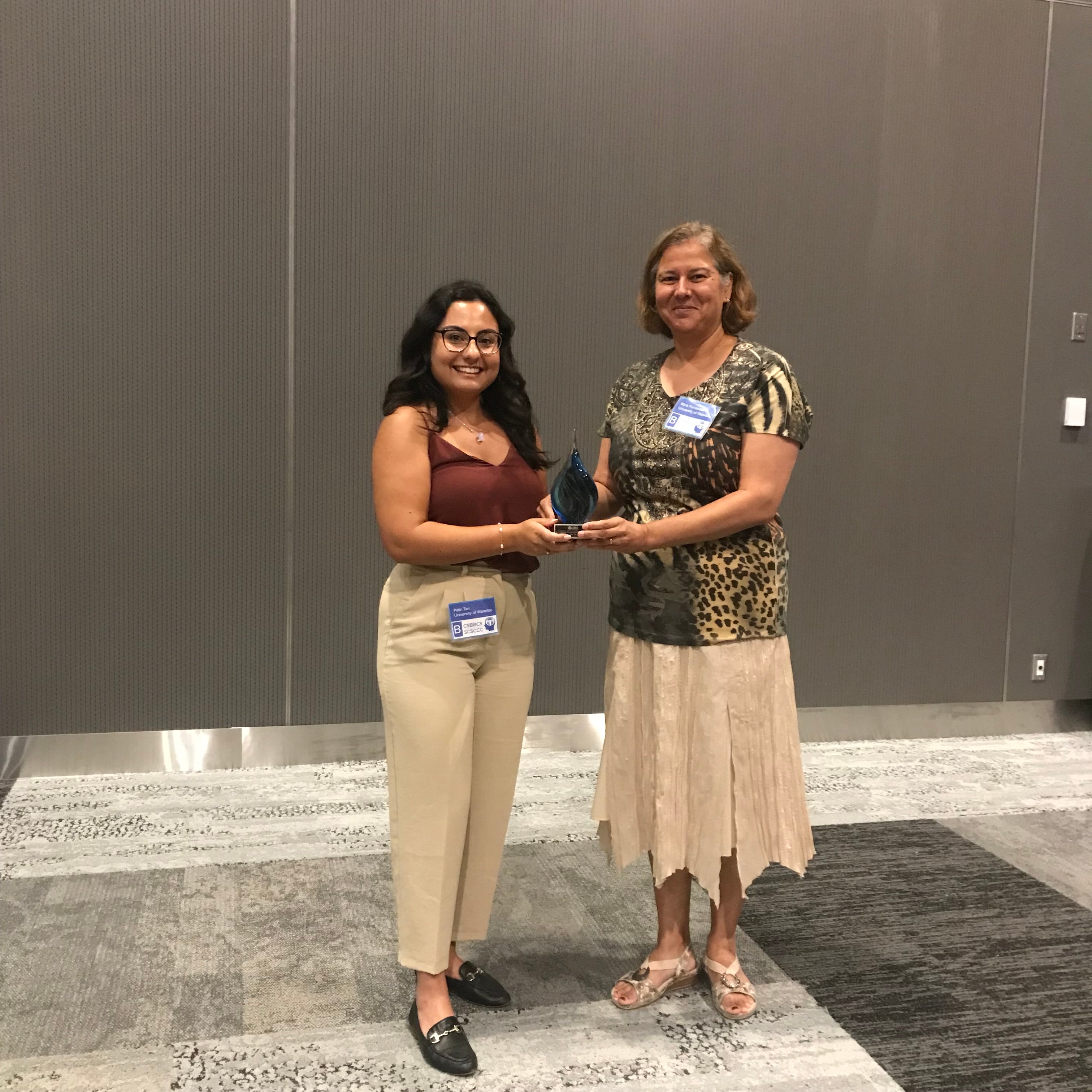 Pelin and Myra holding an award at CSBBCS 2023