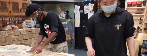 Two theatre students working in the shop