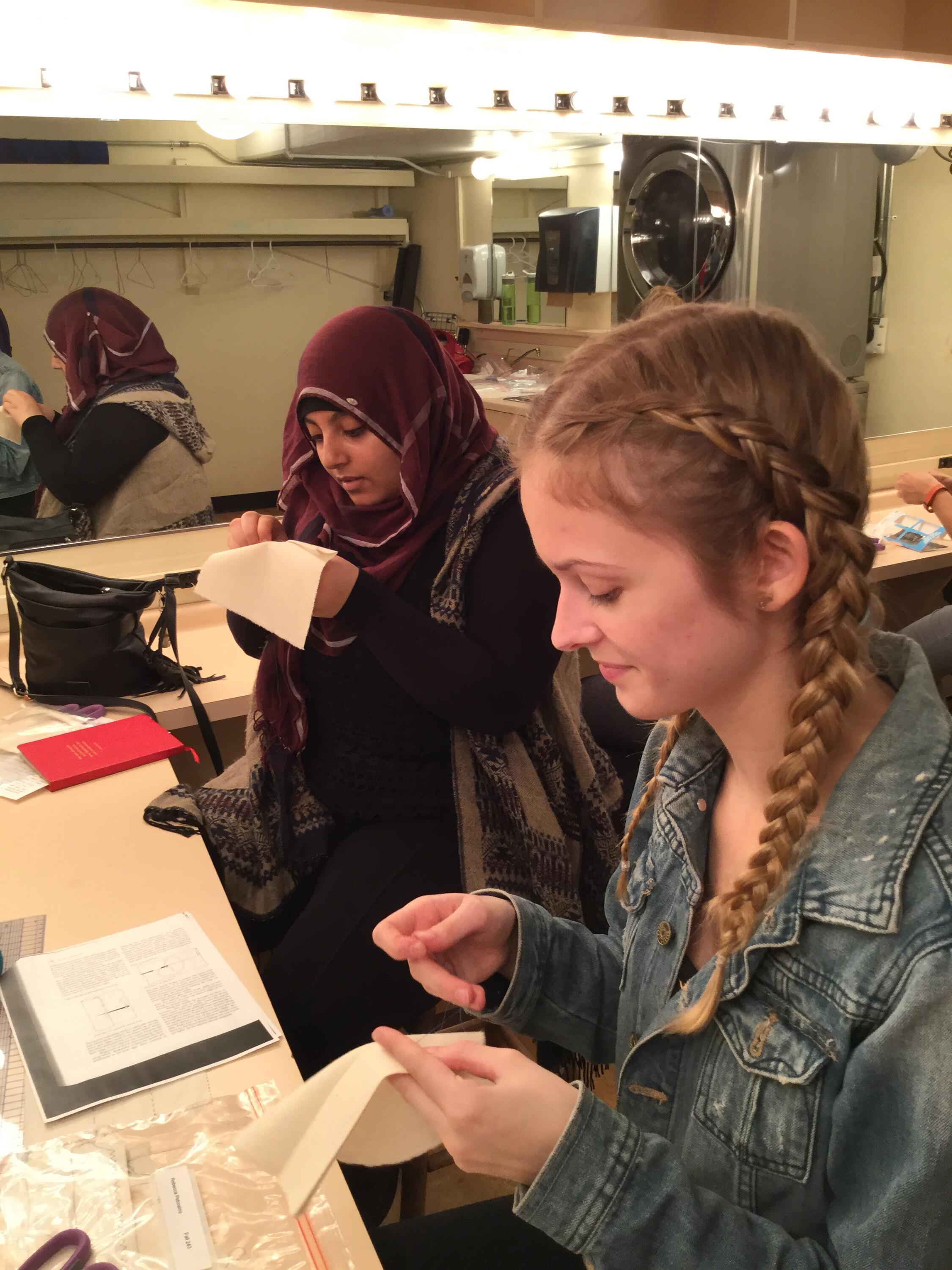 Two students sewing in a workshop