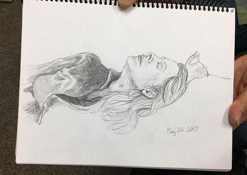 Pencil sketch of a woman lying on a bed