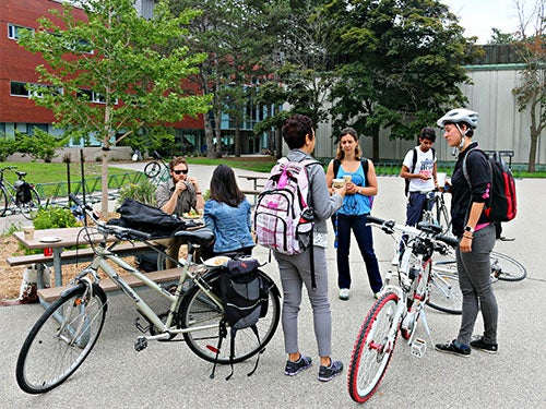 Students engage with a free community breakfast during Bike Month