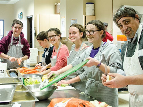 Conrad students voluneering in a kitchen