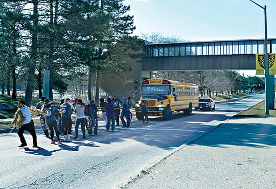 Students pulling a school bus for the annual Engineering Society Bus Push event