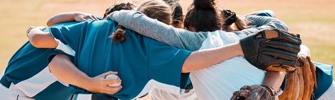 Youth baseball team huddles before a game.