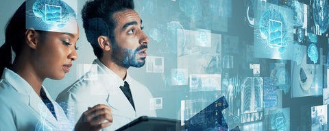 Two researchers looking at a projection