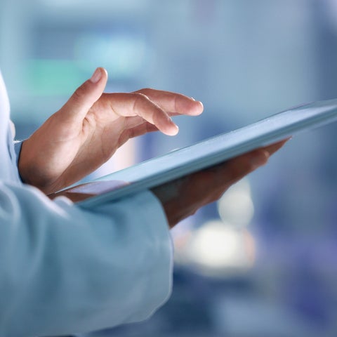 Hand holding a tablet