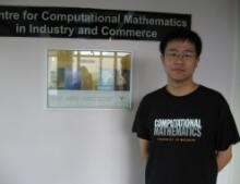 Xiaolu Sun standing in front of Computational Mathematics sign