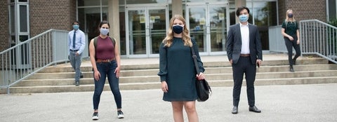 People-standing-outside-building-wearing-masks