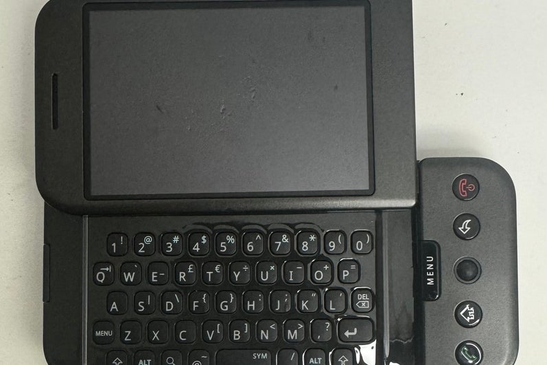 Front of an HTC Dream smartphone showcasing the keyboard.