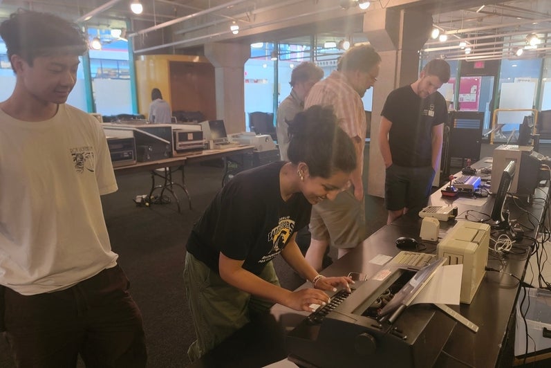 Girl typing on an IBM Selectric III Typewriter