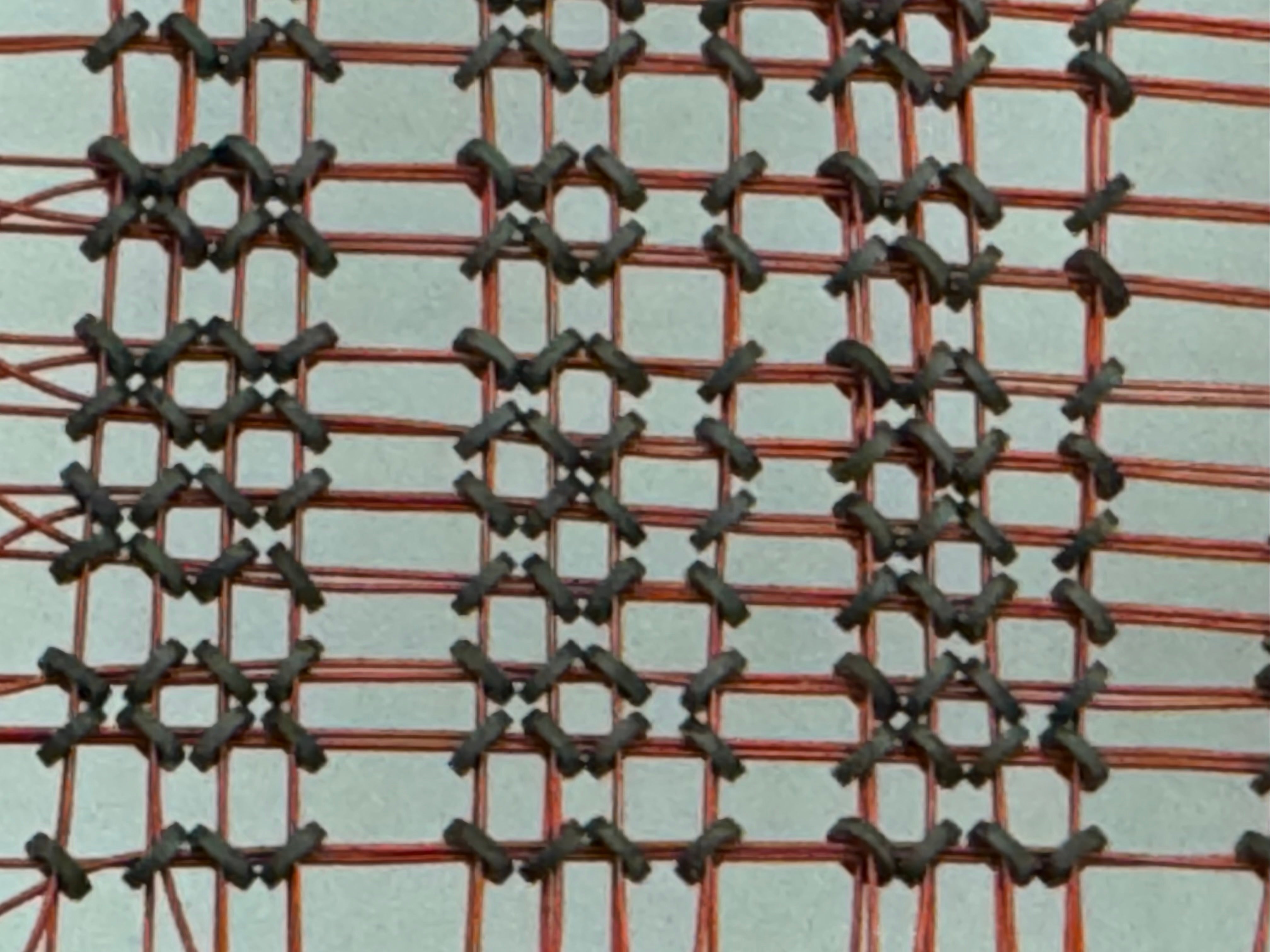Close image of a core memory board with torroids visible 