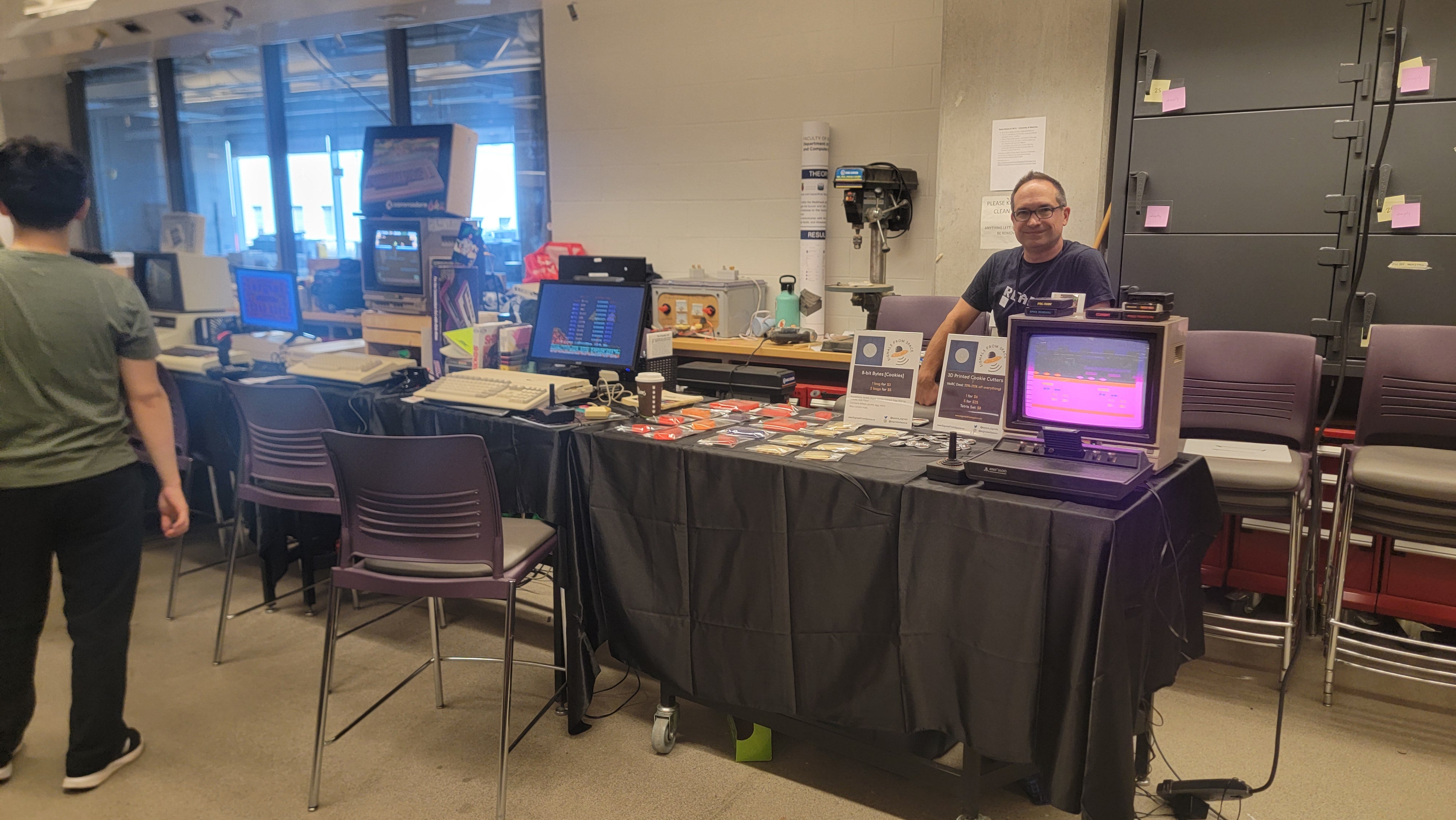 Vendor selling 3D printed cookies and cookie cutters in the shape of retro game characters and other pixel art.