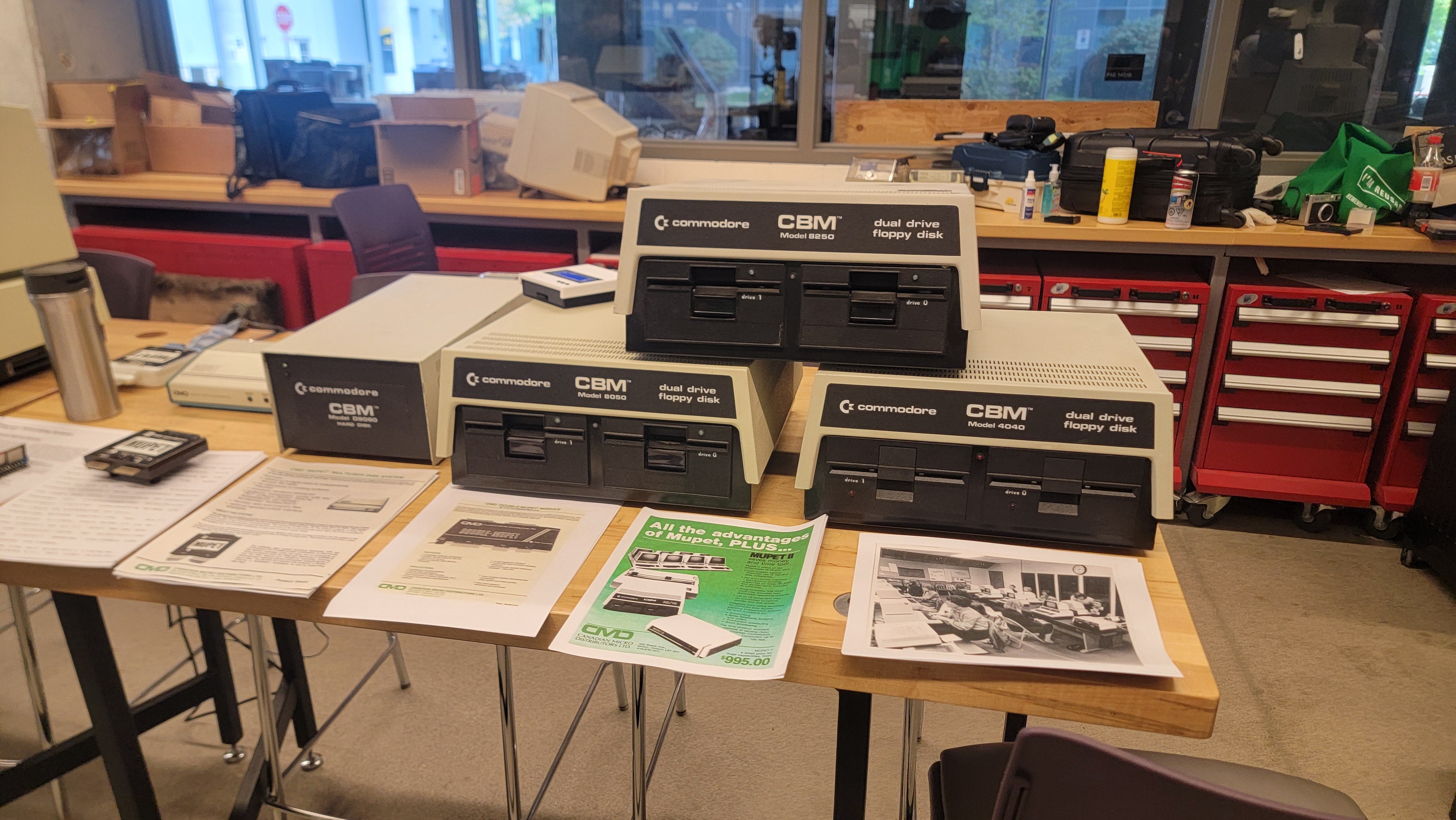 A table with several Commodore 8050 computers. 