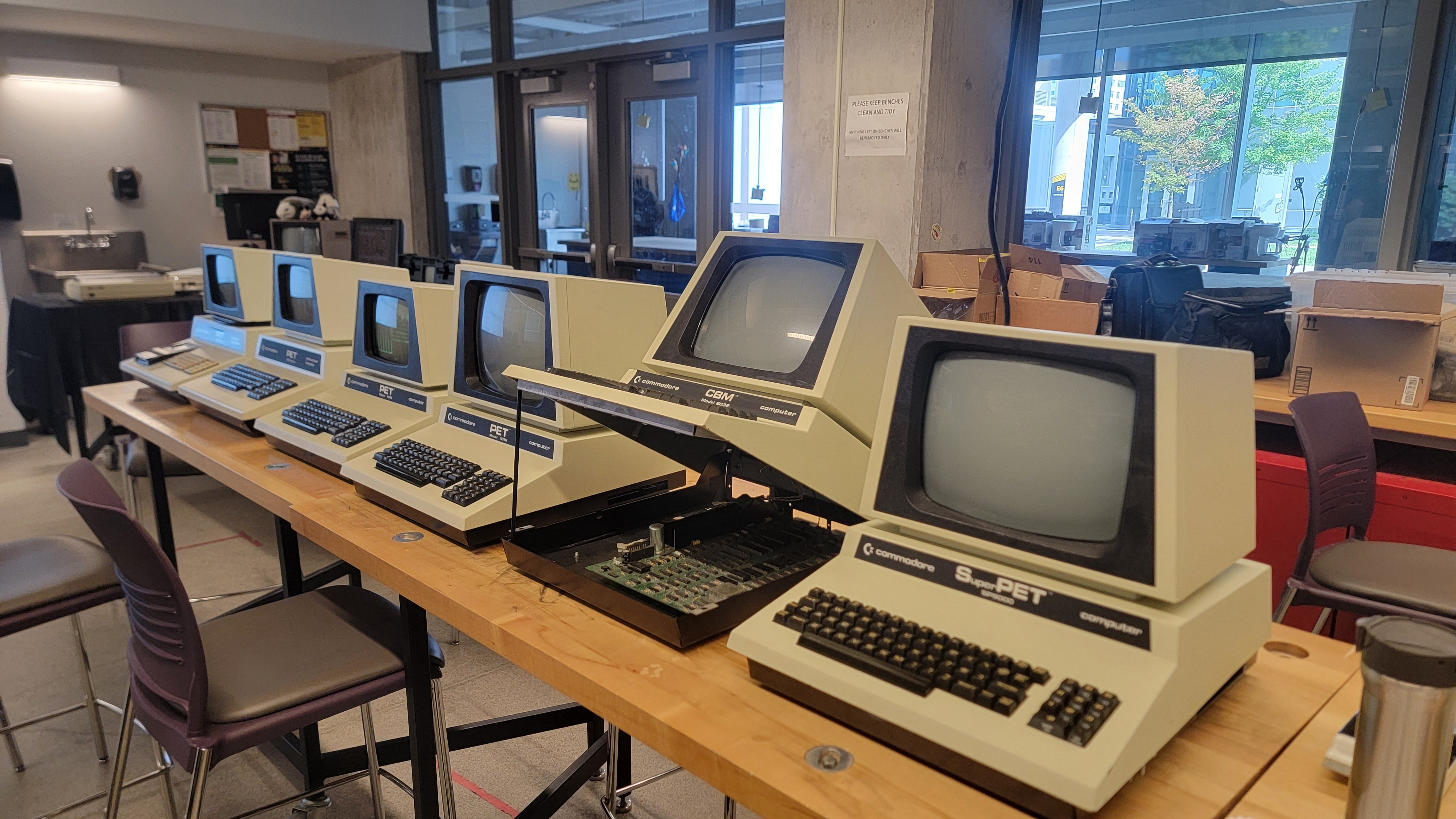 A table with several Commodore SuperPET computers. 