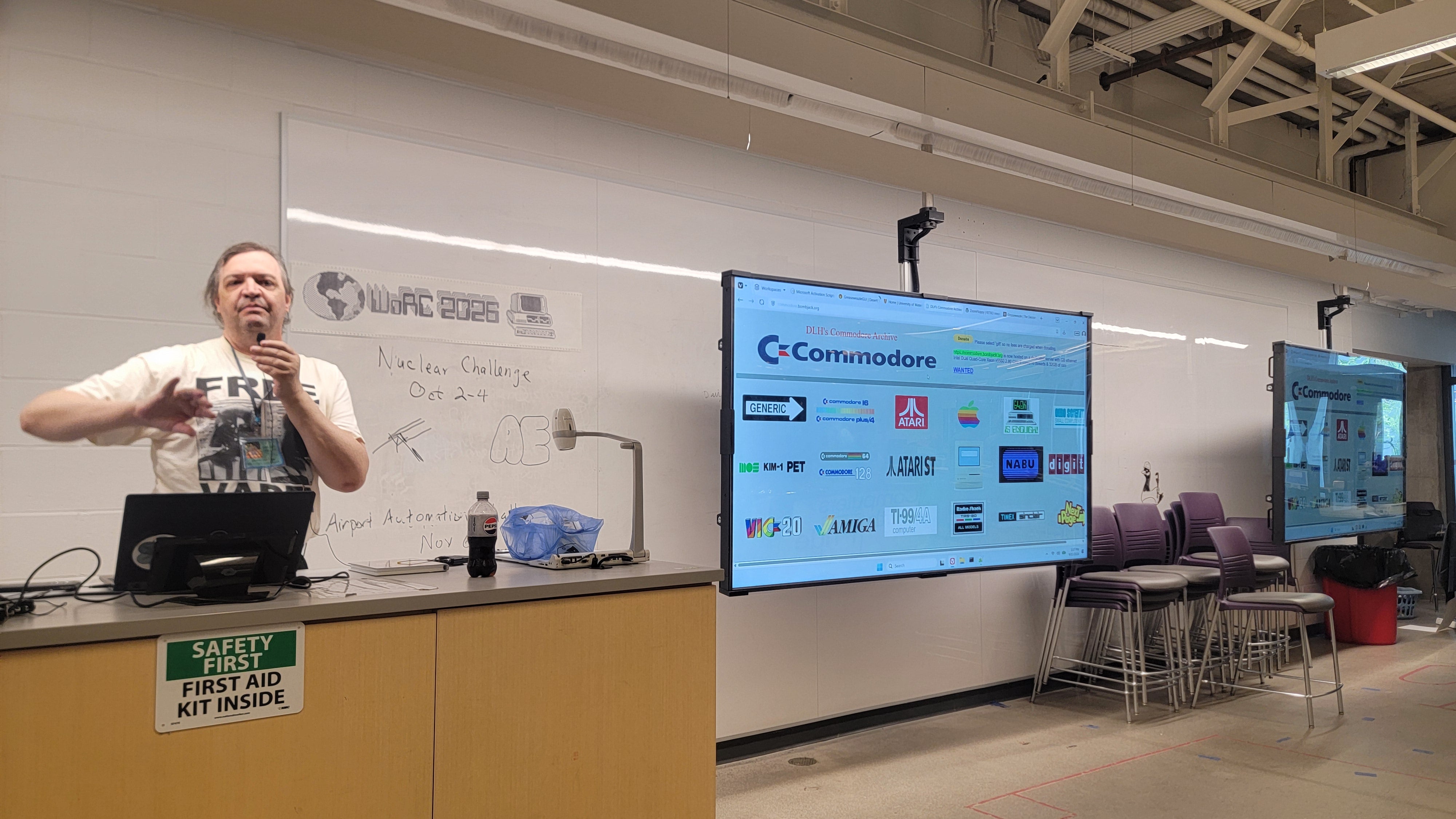 [speaker] giving a talk featuring a slide listing several iconic retro computer models.