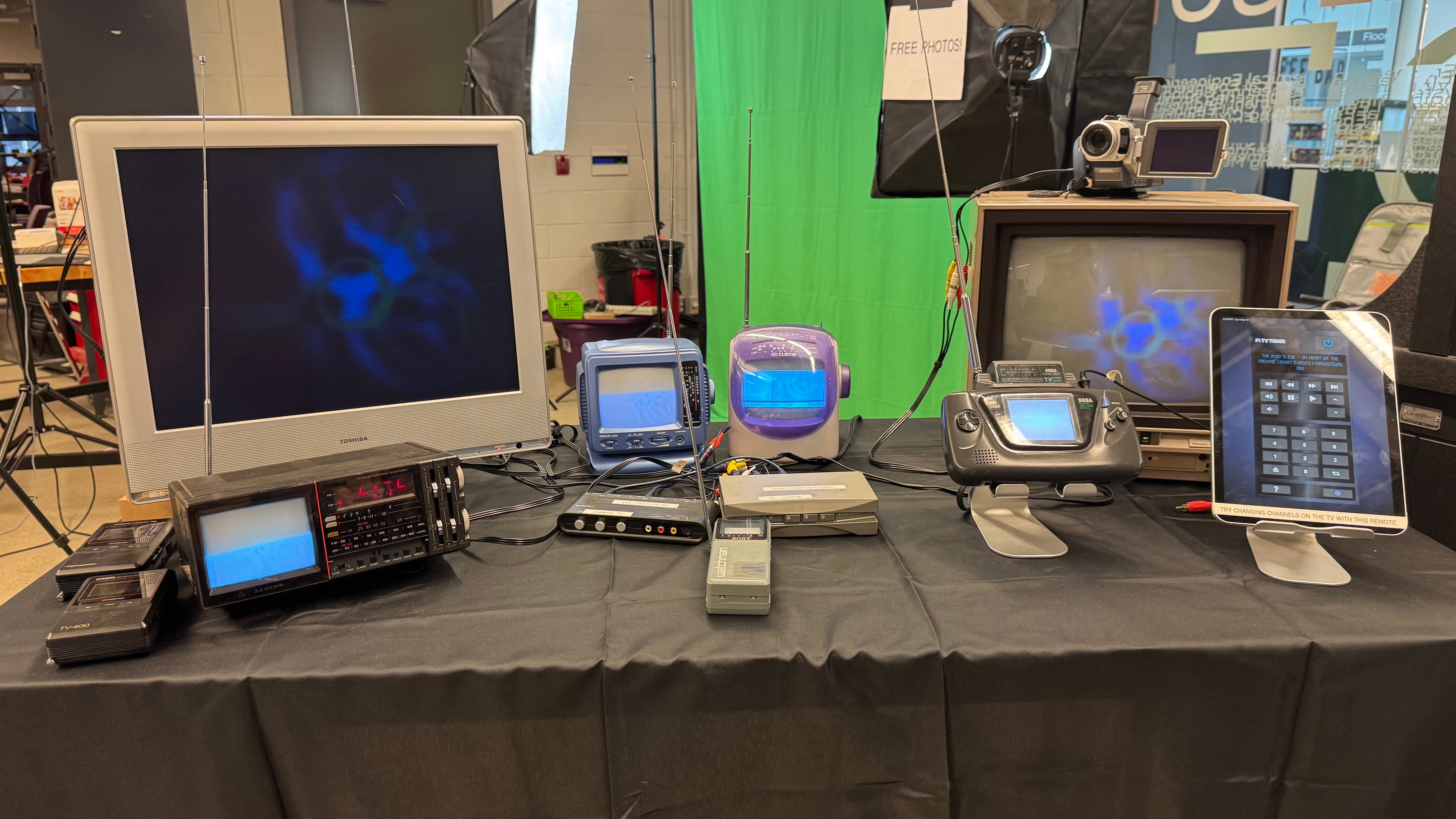 Table with several retro computers and retro handheld devices.